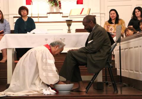 Bishop Jung washes the feet of Co Lay Leader Leslie Hall